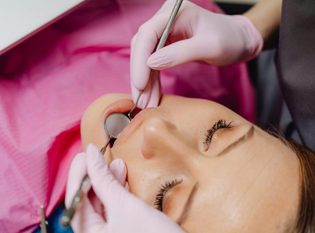 pexels-photo-6627535-6627535 Close-up of a dentist performing a dental examination on a patient.